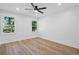 Spacious bedroom with natural light, ceiling fan, and hardwood style floors at 4745 Elam Forest Dr, Stone Mountain, GA 30083