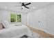 Bedroom features a ceiling fan, closet, and a large window providing an outside view at 4745 Elam Forest Dr, Stone Mountain, GA 30083