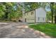 Charming home exterior with a spacious driveway, lush lawn, and a lovely wooden deck at 4745 Elam Forest Dr, Stone Mountain, GA 30083
