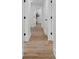 Hallway featuring wood floors and white doors with modern black hardware at 4745 Elam Forest Dr, Stone Mountain, GA 30083