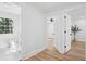 Bright hallway with wood-look flooring and access to a bedroom and bathroom at 4745 Elam Forest Dr, Stone Mountain, GA 30083