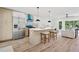Modern kitchen with stainless steel appliances, an island with barstool seating, and lots of sunlight at 4745 Elam Forest Dr, Stone Mountain, GA 30083
