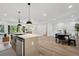 Open kitchen and dining area with stainless steel appliances and an island at 4745 Elam Forest Dr, Stone Mountain, GA 30083
