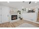 Bright living room features a fireplace and open staircase with white railings at 4745 Elam Forest Dr, Stone Mountain, GA 30083
