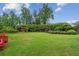 Lush backyard featuring manicured hedges, mature trees, and a charming gazebo at 1624 Glenfield Dr, Lawrenceville, GA 30043