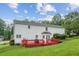 Expansive backyard view featuring a red deck, well-maintained lawn, and mature trees at 1624 Glenfield Dr, Lawrenceville, GA 30043