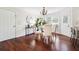 This dining room features hardwood floors, a modern chandelier, and lots of natural light at 1624 Glenfield Dr, Lawrenceville, GA 30043