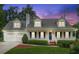 Charming two-story home with a welcoming front porch, two-car garage, and beautiful landscaping at 1624 Glenfield Dr, Lawrenceville, GA 30043