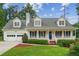 Charming two-story home with a welcoming front porch, two-car garage, and beautiful landscaping at 1624 Glenfield Dr, Lawrenceville, GA 30043