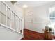 Inviting foyer featuring hardwood floors, a staircase, and a convenient coat closet at 1624 Glenfield Dr, Lawrenceville, GA 30043