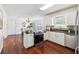 This kitchen features white cabinets, stainless steel appliances, granite countertops, and hardwood floors at 1624 Glenfield Dr, Lawrenceville, GA 30043