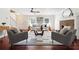 Bright living room features modern decor, hardwood floors, a ceiling fan, and a brick fireplace at 1624 Glenfield Dr, Lawrenceville, GA 30043