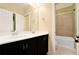 Bathroom with a double sink, dark vanity, and a bathtub shower at 169 Waterman Se St, Marietta, GA 30060