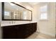 Bathroom featuring dark wood cabinets, dual sinks and a large mirror at 169 Waterman Se St, Marietta, GA 30060