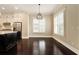 Dining area adjacent to the kitchen, featuring hardwood floors, ample natural light, and stylish pendant lighting fixtures at 169 Waterman Se St, Marietta, GA 30060
