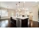 Open concept kitchen showcasing a large island, stainless steel appliances, and seamless flow into the adjacent living area at 169 Waterman Se St, Marietta, GA 30060