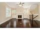 Spacious living room featuring hardwood floors, a fireplace with built-in cabinets, and plantation shutters for natural light at 169 Waterman Se St, Marietta, GA 30060