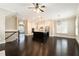 Open-concept living space flowing from the kitchen with views of the fireplace, hardwood floors, and modern lighting at 169 Waterman Se St, Marietta, GA 30060