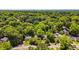 This aerial view shows tree-lined neighborhood with houses nestled amongst the lush greenery at 1834 Broad Ave, Atlanta, GA 30344
