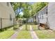 A chain-link fence marks the boundary line between neighboring properties and driveways at 1834 Broad Ave, Atlanta, GA 30344