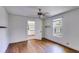 Bedroom with hardwood floors, white walls and ceiling fan with natural light at 1834 Broad Ave, Atlanta, GA 30344
