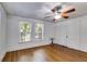 Bright bedroom with hardwood floors, ceiling fan and two windows at 1834 Broad Ave, Atlanta, GA 30344