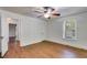 A bright bedroom features hardwood floors, a ceiling fan, and a window for natural light at 1834 Broad Ave, Atlanta, GA 30344