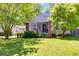 Charming home featuring a screened porch, brick pillars, lovely landscaping and a well-manicured lawn at 1834 Broad Ave, Atlanta, GA 30344