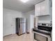 Kitchen featuring stainless steel refrigerator, white cabinets, and tile flooring at 1834 Broad Ave, Atlanta, GA 30344