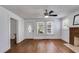 Bright living room featuring hardwood floors, a brick fireplace, and ample natural light at 1834 Broad Ave, Atlanta, GA 30344