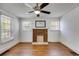 Charming living room with brick fireplace, hardwood floors, ceiling fan, and lots of windows at 1834 Broad Ave, Atlanta, GA 30344