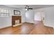 Inviting living room with a brick fireplace, hardwood floors, and abundant natural light at 1834 Broad Ave, Atlanta, GA 30344