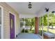 Screened porch with brick columns and a purple door, offering a relaxing outdoor space at 1834 Broad Ave, Atlanta, GA 30344