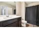 Functional bathroom with a modern vanity, toilet, and a shower featuring a dark curtain, offering essential amenities at 2039 Wildflower Nw Way, Conyers, GA 30012