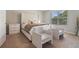 Bright bedroom with a large, upholstered bed, accent chairs, and ample natural light at 2039 Wildflower Nw Way, Conyers, GA 30012