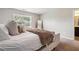 Neutral bedroom featuring a plush bed and a bright window, creating a serene and restful atmosphere at 2039 Wildflower Nw Way, Conyers, GA 30012