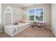 Stylized bedroom with a charming bed frame, decorative storage, and a bright window at 2039 Wildflower Nw Way, Conyers, GA 30012