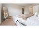Spacious bedroom with neutral tones, comfortable bedding, and a decorative full-length mirror at 2039 Wildflower Nw Way, Conyers, GA 30012