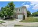 Charming two-story home featuring brick accents, a one-car garage, manicured lawn, and lush green trees at 2039 Wildflower Nw Way, Conyers, GA 30012