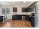 Well-equipped kitchen with stainless steel appliances, granite counters, and dark cabinetry at 2039 Wildflower Nw Way, Conyers, GA 30012