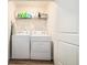 Functional laundry room with a washer, a dryer, and storage shelving at 2039 Wildflower Nw Way, Conyers, GA 30012