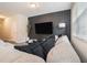 Comfortable living room area featuring a large sofa, contemporary accent wall, and soft lighting at 2039 Wildflower Nw Way, Conyers, GA 30012