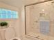 Bathroom with glass door shower, and a glass block window with marble tile at 2437 N Decatur Rd, Decatur, GA 30033