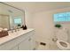 Bright bathroom features a white vanity, marble floors and a tiled shower at 2437 N Decatur Rd, Decatur, GA 30033