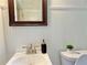 Bathroom featuring white wainscoting, a vanity and a dark framed mirror at 2437 N Decatur Rd, Decatur, GA 30033