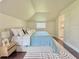 Cozy bedroom featuring light blue bedding, hardwood floors, and neutral walls at 2437 N Decatur Rd, Decatur, GA 30033