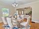 Cozy dining room with hardwood floors, modern light fixture, and open to the living room at 2437 N Decatur Rd, Decatur, GA 30033
