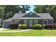 Charming single-story home with gray siding, a covered porch and manicured landscaping at 2437 N Decatur Rd, Decatur, GA 30033