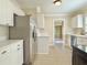 Spacious kitchen featuring tile floors, stainless steel refrigerator, and white cabinetry at 2437 N Decatur Rd, Decatur, GA 30033