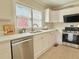 A bright kitchen featuring white cabinets, stainless steel appliances, and a window at 2437 N Decatur Rd, Decatur, GA 30033